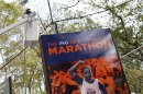 A worker is seen in a bucket truck in front of a sign for the New York City Marathon in the aftermath of Hurricane Sandy in New York