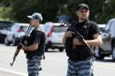 Armed pro-Russian separatists stand guard on the suburbs of Shakhtarsk