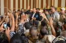 In this photo provided by the Iraqi government, outgoing prime minister Nouri al-Maliki, center, is surrounded by residents and security forces after his arrival in Amirli, some 105 miles (170 kilometers) north of Baghdad, Iraq, Monday, Sept. 1, 2014. Al-Maliki praised residents for fending off attacks by Sunni militants who had besieged them for more than two months until security forces backed by Iran-allied Shiite militias and U.S. airstrikes broke the siege a day earlier. (AP Photo/Iraqi Government)