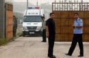 Chinese police wait outside the Number Two prison after the release of dissident Wang Xiaoning