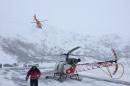 Picture by the Police of the Swiss Canton of Valais shows a helicopter of the Swiss Civil Defence taking off as part of rescuing operations to search for ski hikers following an avalanche near the Grand Saint Bernard pass, on February 21, 2015