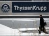 A man walks past a logo of Germany's industrial conglomerate ThyssenKrupp AGat their headquarters in Essen
