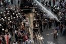 Turkish riot police use a water cannon to disperse protesters during a demonstration in the context of World Peace Day on Sepember 1, 2015 on Istiklal Avenue in Istanbul