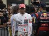 McLaren Formula One driver Lewis Hamilton of Britain walks past Red Bull driver Sebastian Vettel of Germany after the qualifying session of the Brazilian F1 Grand Prix