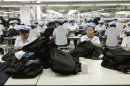 In this Sept. 21, 2012 photo, North Korean workers assemble Western-style suits at the South Korean-run ShinWon Corp. garment factory inside the Kaesong industrial complex in Kaesong, North Korea. On Wednesday, April 3, 2013, North Korea refused entry to South Koreans trying to cross the Demilitarized Zone to get to their jobs managing factories in the North Korean city of Kaesong. Pyongyang had threatened in recent days to close the border in anger over South Korea's support of U.N. sanctions punishing North Korea for conducting a nuclear test in February. (AP Photo/Jean H. Lee)