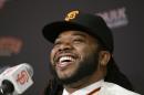 San Francisco Giants pitcher Johnny Cueto smiles during a media availability Thursday, Dec. 17, 2015, in San Francisco. Cueto was introduced by the Giants a day after passing his physical to complete a $130 million, six-year contract. Cueto, who helped the Royals win the World Series, joins a rotation led by Madison Bumgarner and new addition Jeff Samardzija. (AP Photo/Eric Risberg)