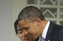 U.S. President Barack Obama, right, walks out with Myanmar opposition leader Aung San Suu Kyi after addressing members of the media at Suu Kyi's residence in Yangon, Myanmar, Monday, Nov. 19, 2012. Obama who touched down Monday morning, becoming the first U.S. president to visit the Asian nation also known as Burma, said his historic visit to Myanmar marks the next step in a new chapter between the two countries. (AP Photo/Pablo Martinez Monsivais)