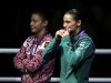 Katie Taylor of Ireland kisses her gold medal as silver medallist Sofya Ochigava of Russia looks on during the medal ceremony for the Women's Light (60kg) boxing competition at the London Olympic Games