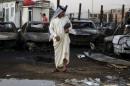 A man looks at the site of a car bomb attack at the mainly Shi'ite district of Habibiya in Baghdad