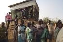 People arrive to seek refuge in the UNMISS compound in Juba, on December 18, 2013