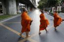File photo of Buddhist monks crossing highway early morning in Bangkok,