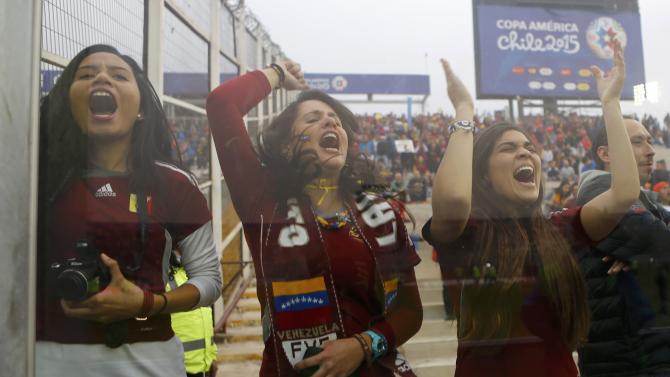 Venezuela fans are seen through a window as they await the first round Copa America 2015 soccer match against Brazil at Estadio Monumental David Arellano in Santiago