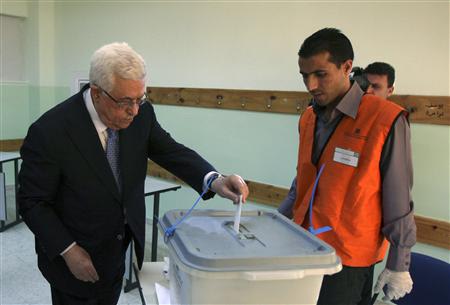 Palestinian President Abbas casts his vote for municipal elections at a polling station in Al-Bireh