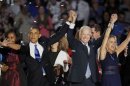 U.S. President Barack Obama stands with his wife Michelle and Vice President Biden and his wife Jill as they face supporters following his acceptance speed during his election night victory rally in Chicago