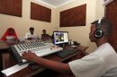 Qaran radio reporters broadcast morning news from their studio in Mogadishu