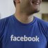 FILE - This Feb. 8, 2012 file photo shows a Facebook worker smiling inside Facebook headquarters in Menlo Park, Calif.  Facebook says 25 percent more shares will be sold as investors clamor for a piece of the year's hottest stock offering. Facebook said in a regulatory filing Wednesday, May 16, 2012 that about 421 million shares will be sold, up from 337 million under its earlier plans. The news comes a day after Facebook raised the expected price range for the stock to a range of $34 to $38 per share, up from $28 to $35.  (AP Photo/Paul Sakuma, File)