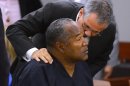 O.J. Simpson and his defense attorney Ozzie Fumo confer during an evidentiary hearing for Simpson in Clark County District Court on May 17, 2013 in Las Vegas. Simpson, who is currently serving a nine-to-33-year sentence in state prison as a result of his October 2008 conviction for armed robbery and kidnapping charges, is using a writ of habeas corpus to seek a new trial, claiming he had such bad representation that his conviction should be reversed. (AP Photo/Ethan Miller, Pool)