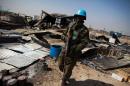 A UN peacekeeper from Rwanda walks through the remnants of a looted and burnt clinic in the UN Protection of Civilians site in Malakal, on February 26, 2016