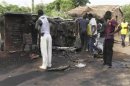 People gather around a burnt Seleka Rebel truck in Begoua
