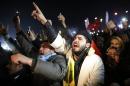 Supporters of Turkey's PM Erdogan shout slogans as they gather to welcome his arrival in Ankara