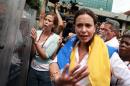 Venezuelan opposition lawmaker Maria Corina Machado (C) gestures in front of the national police at the end of a political gathering at a square in Caracas on April 1, 2014