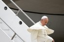 Pope Francis deplanes upon his arrival at the international airport in Rio de Janeiro, Brazil, Monday, July 22, 2013. During his seven-day visit, Francis will meet with legions of young Roman Catholics converging on Rio for the church's World Youth Day festival.(AP Photo/Jorge Saenz)