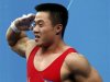 North Korea's Un Guk Kim salutes celebrating his new world record in total of the men's 62Kg weightlifting competition at the London 2012 Olympic Games