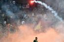 Yasyn Alnakhli of Saudi Arabia walks off the pitch after flares were thrown on the pitch during the 2018 World Cup qualifying football match between Malaysia and Saudi Arabia in Shah Alam on September 8, 2015