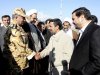 In this image provided by the Presidency Office, Iranian President Mahmoud Ahmadinejad, second right, shakes hand with an unidentified army colonel as he arrives at the Shahr-e-Kord, during his provincial tour, in central Iran, Wednesday, Nov. 9, 2011. Iran won't retreat "one iota" from its nuclear program but the world is being misled by claims that it seeks atomic weapons, President Mahmoud Ahmadinejad said Wednesday in his first reaction since a U.N. watchdog report that Tehran is on the brink of developing a warhead. (AP Photo/Presidency Office, Ebrahim Seyyedi, HO) EDITORIAL USE ONLY, NO SALES