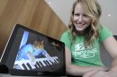 Katie Hill, a program associate with the Walker Art Center, shows a frame from a cat video of a cat playing the piano Wednesday, Aug. 29, 2012, in Minneapolis. The Walker will present its first "Internet Cat Video Film Festival" to showcase the best in filmed feline hijinks. (AP Photo/Jim Mone)