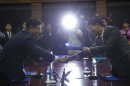 Head of the South Korean working-level delegation Suh Ho and his North Korean counterpart Park Chol-su exchange written agreements in Panmunjom