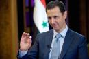 In this photo released on Tuesday, Feb. 10, 2015 by the Syrian official news agency SANA, Syrian President Bashar Assad gestures during an interview with the BBC, in Damascus, Syria. Assad said in comments published Tuesday that his government has been receiving general messages from the American military about airstrikes targeting the Islamic State group inside Syria but that there is no direct cooperation. (AP Photo/SANA)