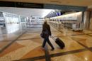 A lone traveller moves past the empty check-in gates of United Airlines in the main terminal at Denver International Airport as a severe spring storm packing high winds and heavy, wet snow sweeps over the intermountain West forcing the cancellation of hundreds of flights, Saturday, April 16, 2016, in Denver. (AP Photo/David Zalubowski)