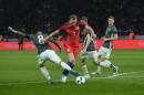 England's striker Harry Kane (2L) and Germany's midfielder Mesut Oezil vie for the ball during the friendly football match at the Olympic Stadium in Berlin on March 26, 2016