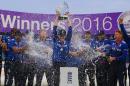 England captain Eoin Morgan (C) raises the series trophy as his team-mates spray him with champagne at the end of play in their fifth ODI match against Pakistan, at The SWALEC Stadium in Cardiff, south Wales, on September 4, 2016