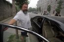 Chinese dissident artist Ai Weiwei closes the door of a car as his wife Lu Qing in leaves for the courthouse before his verdict hearing in Beijing