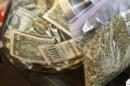 A bag of marijuana being prepared for sale sits next to a money jar at BotanaCare in Northglenn, Colorado