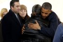 President Barack Obama hugs a woman as he visits the FEMA recovery center on the grounds of New Dorp High School, Thursday, Nov. 15, 2012 on Staten Island, in New York. At left is Rep. Michael Grimm, R-N.Y. (AP Photo/Carolyn Kaster)