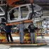 Chrysler Group assembly workers lower frame onto chassis for Chrysler Jeeps, Grand Cherokees and Dodge Durangos at Chrysler Jefferson North auto plant in Detroit, Michigan