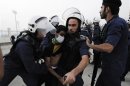 Riot police arrest an anti-government protester during clashes in the village of Daih, west of Manama