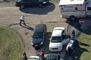 In this aerial image provided by KDKA-TV, emergency personal head to the scene near Brashear High School in Pittsburgh, Wednesday, Nov. 13, 2013. Pittsburgh police reported Wednesday that three people were shot near the school. The condition of the person in the stretcher was unknown Wednesday. (AP Photo/KDKA-TV)