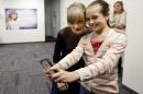 Taylor Swift poses for a photo with Piper Moralez, 11, at the Country Music Hall of Fame and Museum on Saturday, Oct. 12, 2013, in Nashville, Tenn. Swift is at the facility to open the $4 million Taylor Swift Education Center. (AP Photo/Mark Humphrey)