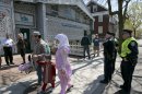 Police stand by as Muslims leave the Islamic Society of Boston mosque, Friday, April 26, 2013, in Cambridge, Mass. Leaders of the Islamic Society of Boston said Tamerlan Tsarnaev occasionally attended Friday prayers, but had protested the community's moderate approach. (AP Photo/Robert F. Bukaty)
