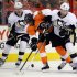 Philadelphia Flyers' Wayne Simmonds, center, gets taken off the puck by Pittsburgh Penguins' Beau Bennett, left, and James Neal, right in the second period of an NHL hockey game, Thursday, March 7, 2013, in Philadelphia. (AP Photo/Tom Mihalek)