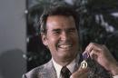 FILE - Actor James Garner, left, smiles as he holds up the Purple Heart medal presented to him in a ceremony in this Monday, Jan. 24, 1983 file photo taken Los Angeles, Calif. Garner was wounded in April 1951 while with U.S. Forces in Korea, but his medal was never presented to him. Actor James Garner, wisecracking star of TV's "Maverick" who went on to a long career on both small and big screen, died Saturday July 19, 2014 according to Los angeles police. He was 86. (AP Photo/Lennox McLendon, File)