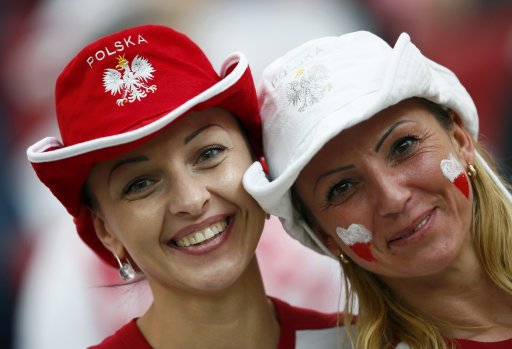 Poland fans smile before the start of their Group A Euro 2012 soccer match against Greece at the National stadium in Warsaw