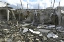 Buildings damaged by what activists said were missiles fired by a Syrian Air Force fighter jet are seen at Houla