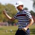 U.S. golfer Simpson celebrates sinking a birdie putt to win the 10th hole during the 39th Ryder Cup singles golf matches at the Medinah Country Club