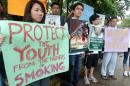 Various civic organizers campaign for a law for graphic health warnings on tobacco products in Manila on June 10, 2014