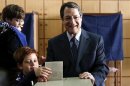 Cyprus presidential candidate Nicos Anastasiades of the right wing Democratic Rally party and his grandsons cast a ballot at a polling station in Limassol